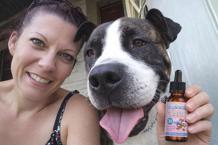 Woman holding a bottle of DogAurum Collagen supplement next to a dog.
